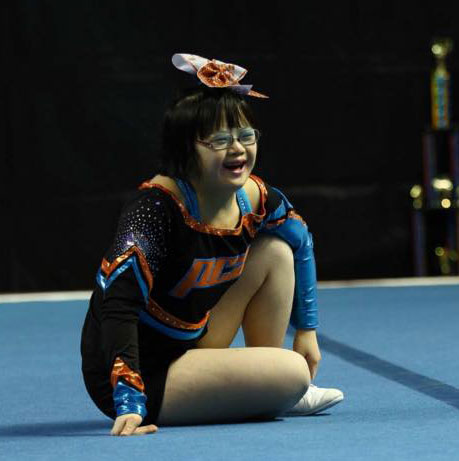 Young woman smiling in a Pegasus Cheer Athletics' uniform